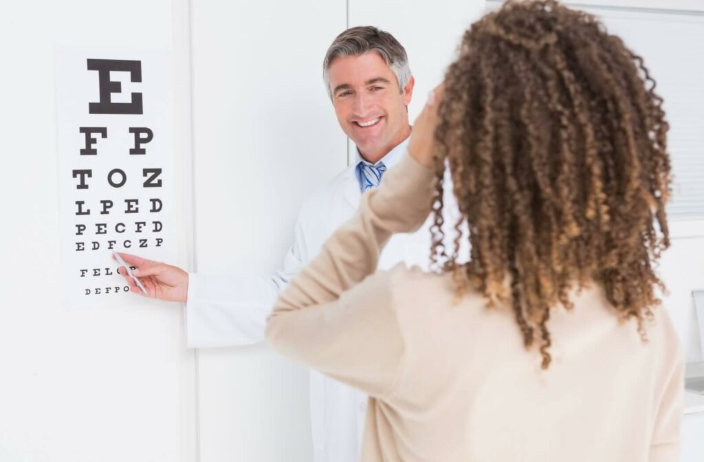 An eye doctor gets their patient to read a Snellen eye chart to test visual acuity.